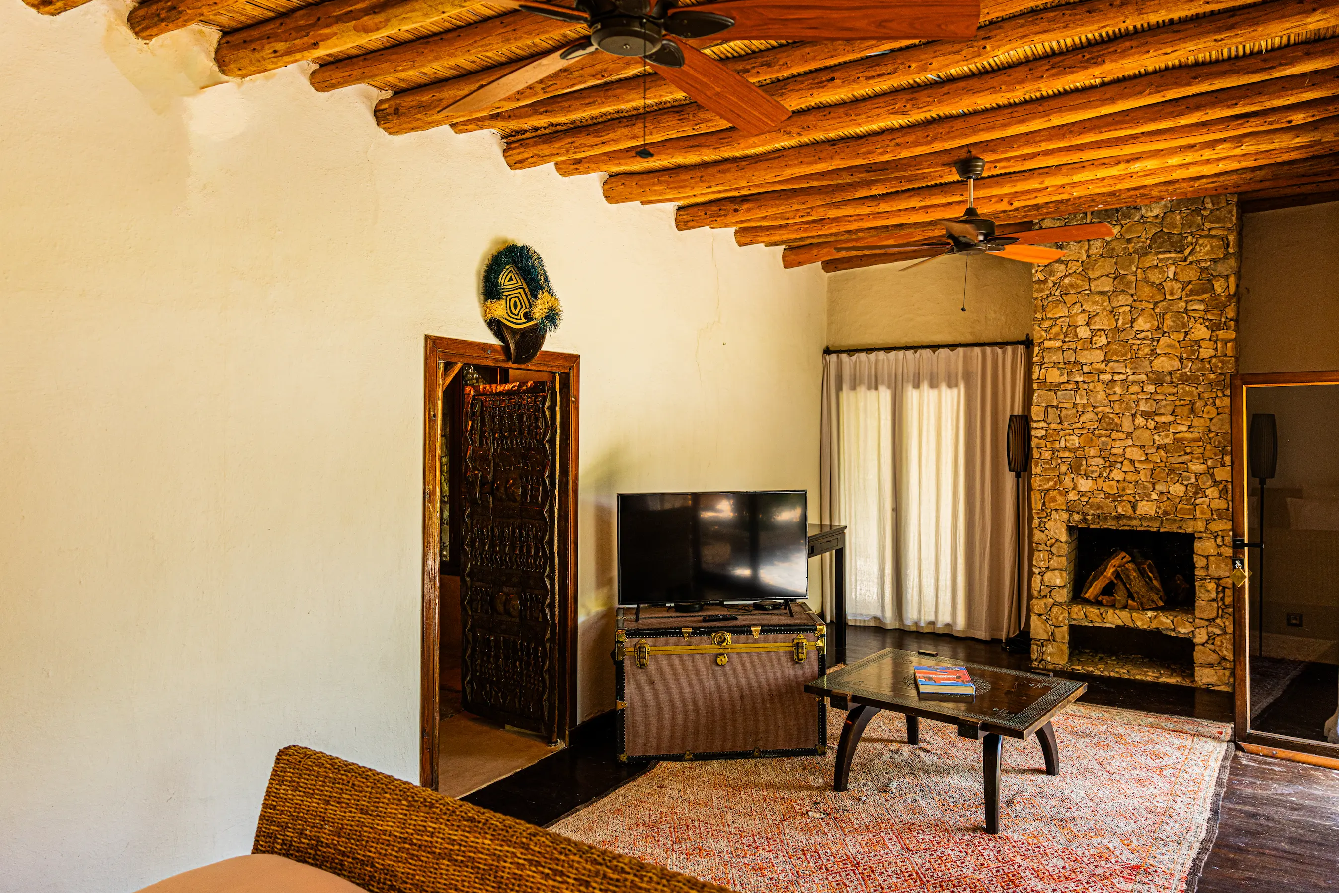 Romantic Suite with TV at Pure Farmhouse Horizontal view of the romantic adults-only suite with a flat-screen TV at Pure Farmhouse Lalla Takerkoust